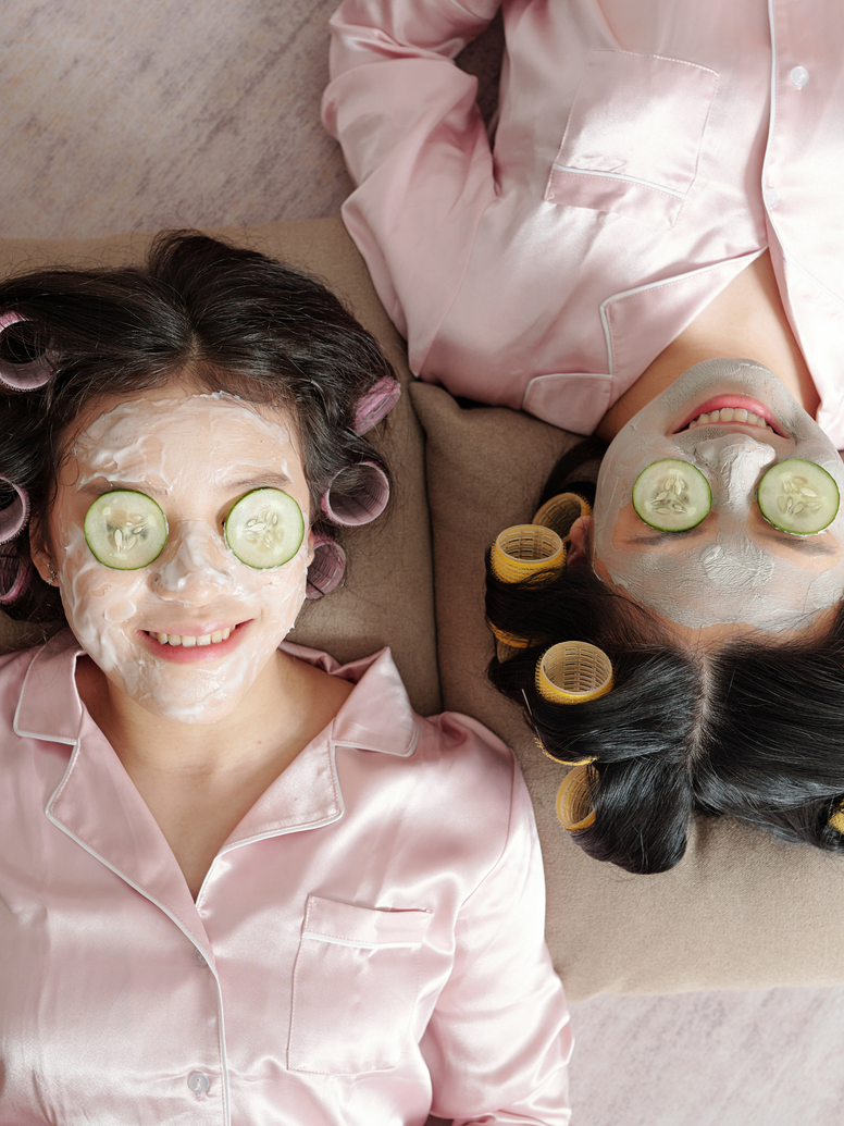 Girls in rollers and cucumber masks